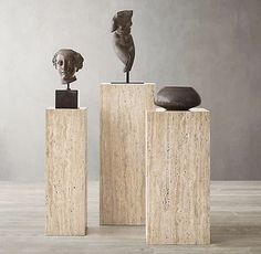 three sculptures sitting on top of wooden blocks