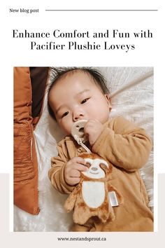 a baby laying on top of a bed with a stuffed animal in it's mouth