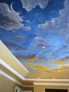 the ceiling is painted with blue and yellow clouds