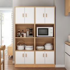 a white microwave oven sitting on top of a wooden shelf next to a kitchen counter