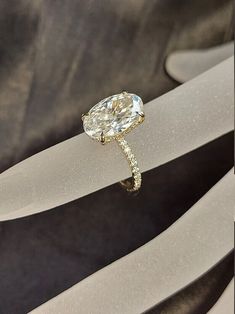 a diamond ring sitting on top of a piece of glass