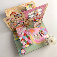 an open doll house on top of a table