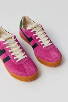 Classic Elan sneakers by Gola in a low top silhouette. Features a lace closure to the front and finished with a durable rubber sole. Features Classic court sneakers from Gola Lace-up style Content + Care Leather, suede, rubber Spot clean Imported Size + Fit Please note, these Gola shoes are sold in US women's shoe sizes | Gola Elan Sneaker in Fuchsia/Black/Evergreen, Women's at Urban Outfitters