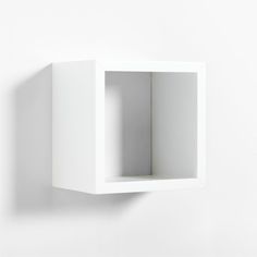 a white wall mounted cabinet with an open door on the front and back sides, against a white background