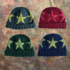 three knitted hats with stars on them, one is red, one is green and the other is blue