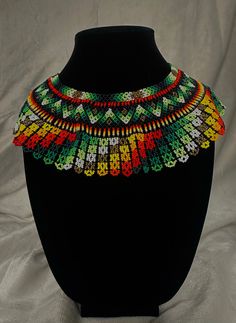 Hand made beaded necklace made by the Embera Chami people native to Colombia. The necklace is light weight and fits most neck sizes. Perfect for any occasion. Southwestern Handwoven Beaded Necklaces For Festivals, Southwestern Style Beaded Necklace For Festivals, Southwestern Style Handwoven Beaded Necklace For Festivals, Green Southwestern Beaded Necklaces For Festival, Southwestern Green Beaded Necklaces For Festivals, Southwestern Green Beaded Necklace For Festivals, Southwestern Beaded Chain Necklace For Festivals, Southwestern Style Beaded Chain Necklace For Festival, Multicolor Handwoven Southwestern Necklaces