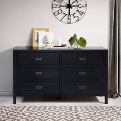 a clock on the wall above a dresser