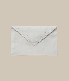 a white envelope with scalloped edges