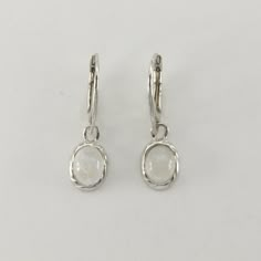 These is a beautiful pair of Sterling Silver Earrings with a Rainbow Moonstone Gemstone. The earrings are made out of solid 925 Silver and there is no nickel or other substances causing most allergies. This makes the earrings hypo allergenic. Size of one Earring in total 4.0 x 1.2 cm or  1.57 x 0.47 inch The hooks are 1.80 cm - or about 3/4 inch - in length. You will receive the item in a gift box - perfect to surprise someone or yourself. Usually we ship on the same day we receive the payment f White Sterling Silver Oval Earrings, Adjustable Oval Sterling Silver Earrings, White Oval Sterling Silver Earrings, Nickel-free Oval Sterling Silver Earrings, Nickel-free Oval Earrings For Anniversary, Elegant Sterling Silver Oval Pendant Earrings, Elegant Nickel-free Oval Pendant Earrings, Sterling Silver Oval Pendant Earrings In Silver, Silver Oval Earrings With Lever Back Ear Wires