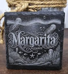 a black slate coaster with the words margarita on it