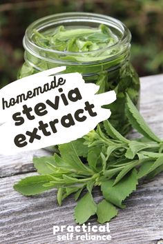 a jar filled with green herbs sitting on top of a wooden table