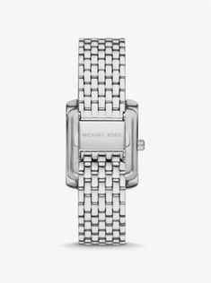 Side panels of understated pavé crystals add shine to the rectangular face of our petite Emery watch. The polished beveled strap is made of silver-tone stainless steel, while the iridescent blue dial features Roman numeral indexes for a luxurious finish. Glamorous enough to pair with evening looks yet understated enough to complement a simple T-shirt and jeans, this is a timeless style you’ll never want to take off. Timeless Silver Square Watch, Silver Rectangular Watch With Polished Finish, Timeless Silver Rectangular Diamond Watch, Michael Kors Silver Jewelry With Diamond Hour Markers, Silver Square Watch With Metal Dial, White Gold Rectangular Watch With Metal Dial, Rectangular White Gold Watch With Metal Dial, Elegant Silver Watch With Square Face, Luxury Silver Rectangular Watch