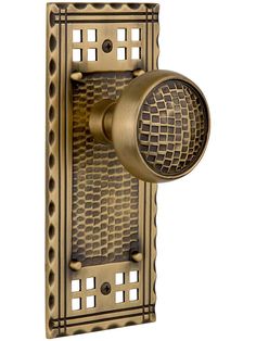 an antique brass finish wall light with a decorative design on the front and back side