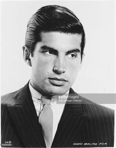 an old black and white photo of a man in a suit with a striped tie