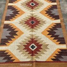 an old navajo rug is laying on the floor