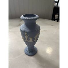 a blue vase sitting on top of a table