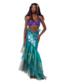 a woman in a blue and green mermaid costume with her hands on her hips,