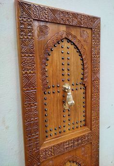 an intricate wooden door with a dog on it