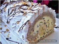 a cake with white frosting and chocolate sprinkles is on a plate