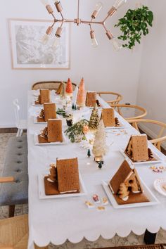 a dining room table with gingerbread houses on it