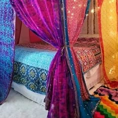 the canopy bed is decorated with bright colors and sequins on it's sides