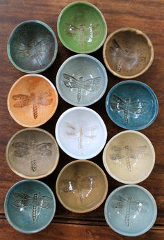 nine dragonflys are painted on small bowls