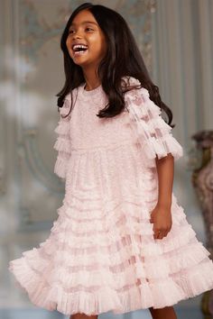 Description & Details NEW SEASON. The La Vie En Rose Kids Dress in Peony Pink / Cream. This beautiful dress is adorned with delicate tulle ruffles, engineered throughout the panels to enhance the silhouette. Crafted with gathered tulle in a contrast colour to the base fabric creates a soft, gentle effect. The perfect dress for all their upcoming special events. - Kisses tulle decorated with layers of tulle ruffles - Bodice and skirt are fully lined, sleeves are unlined - 100% Recycled polyester Editorial Dress, Children Poses, Tulle Ruffles, Full Tulle Skirt, Peony Pink, Event Outfit, Needle Thread, Tulle Fabric, Girl Clothes