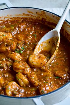 a large pot filled with shrimp and sauce