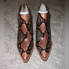 A Split Shaft Adds A Distinctive, Modern Touch To A Pointy-Toe Bootie Set On A Lofty Stacked Heel. - Pointed Toe - Covered Vamp - Snakeskin Embossed Upper - Back Zip Closure - Notched Sides - Stacked Block Heel Leather Boots With Snake Print For Spring, Snake Print Leather Boots With Pointed Toe, Western Style Medium Width Heels With Pointed Toe, Leather Snake Print Round Toe Heels, Medium Width Leather Snake Print Heels, Snake Print Boots With Medium Width And Almond Toe, Snake Print Boots With Almond Toe And Medium Width, Snake Print Pointed Toe Heels Medium Width, Snake Print Leather Heels Medium Width