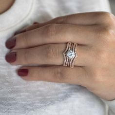 a woman's hand with a diamond ring on it