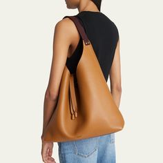 Chloe "Marcie" hobo bag in grained leather  Flat shoulder strap Open top with center straps  Interior, one zip pocket  Approx. 9.1"H x 11.8"W x 3.5"D Professional cleaning recommended Made in Italy Cognac Textured Leather Bag For On-the-go, Double Handle Pebbled Leather Shoulder Bag For On-the-go, Cognac Textured Leather Top Handle Shoulder Bag, Daily Use Calf Leather Tote Bag, Rectangular Pebbled Leather Bag For Shopping, Brown Calf Leather Tote Shoulder Bag, Shopping Pebbled Leather Textured Satchel, Cognac Calf Leather Tote Bag, Cognac Textured Leather Shoulder Bag