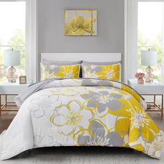 a bed with yellow and gray flowers on it