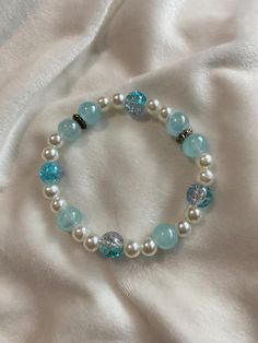 A blue handmade bracelet with some white pearl beads. Cute Blue Bracelet, Elegant Handmade Light Blue Beaded Bracelets, Trendy Light Blue Handmade Beaded Bracelet, Cute Handmade Blue Beaded Bracelets, Blue Beaded Pearl Bracelet, Bracelet Blue, Blue Bracelet Ideas, Cute Beaded Bracelets, Ocean-inspired Blue Beaded Bracelets