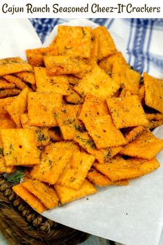 baked cheesy crackers in a wicker basket on top of a blue and white checkered table cloth