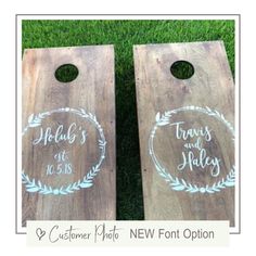 two cornhole game boards with the names of their wedding guests and date printed on them