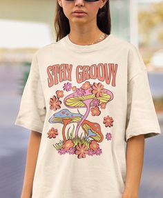 Stay Groovy is a perfect 70s inspired retro shirt for people who loves hippie groovy aesthetic and mushrooms. Add this 70s retro shirt to your Aesthetic Clothes collection! Also available on back print tshirts, sweatshirts and hoodies: Browse through my other awesome items here: http://thenims.etsy.com/ UNISEX TEES Gildan 5000™ (CUSTOMER FAVORITE) * 100% Cotton (fiber content may vary for different colors) * Medium fabric (5.3 oz/yd² (180 g/m * Classic fit * Tear away label * Runs true to size * 70s Shirt Design, Mushroom Shirt Design, Retro Graphic Tshirt, 70s Tshirt Design, Groovy Tshirt Design, Hippy Shirts, Indie Tshirt, 70s Tshirt, Groovy Clothing