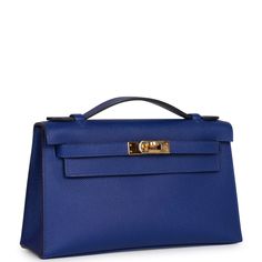 This rare Mini Kelly Pochette is in Bleu Electric epsom leather with gold hardware and has tonal stitching, front flap, two straps with center toggle closure and a top flat handle. The interior is lined with Bleu Electric chevre and has an open wall pocket. Collection: A Origin: France Condition: - Excellent; the bag retains its structure. The leather shows light signs of prior wear. The hardware shows scratching. The inside is clean with light signs wear. Accompanied by: Hermes box, Hermes dust Hermes Pochette Kelly, Hermes Kelly Pochette, Kelly Pochette, Mini Kelly, Open Wall, Hermes Box, Fancy Bags, Hermes Shoes, Fendi Shoes