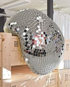 a large mirror ball sitting on top of wooden crates