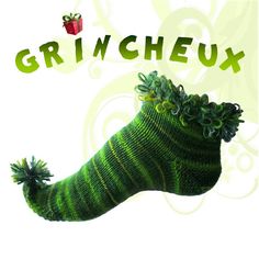 a knitted green sock with the words grineux on it