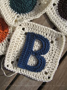 four crocheted coasters with the letter b on them