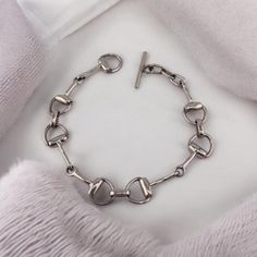 Elevate your style with this sophisticated Sterling Silver Bracelet, featuring a unique interlocking design that exudes elegance and modernity. The interlocking links create a fluid, seamless look, symbolizing connection and unity, making this bracelet not only a fashion statement but also a meaningful accessory. The bracelet is secured with a classic toggle clasp, offering both style and functionality, ensuring it stays comfortably in place all day. This versatile bracelet is perfect for any oc