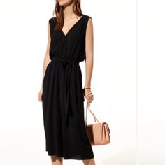 Staple Black Jumpsuit From Aritzia In A Drapey Crepe Material With Tie Waist Size Medium But Runs Large Has Babaton Card Tag Attached But The Style Tag Has Been Removed Sold Out Online Elegant V-neck Jumpsuits And Rompers For Daywear, Formal Black Jumpsuit With Tie Waist, Crepe Material, Aritzia Pants, Aritzia Babaton, Black Jumpsuit, Waist Size, Pant Jumpsuit, Jumpsuit Romper