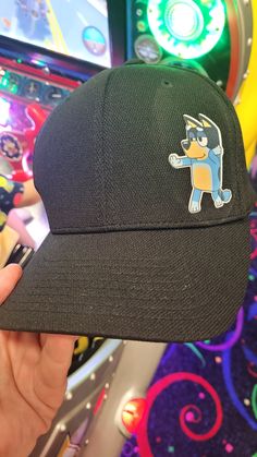 Bluey Themed with Bandit and Unicorse Hat.  (Custom Characters/designs welcomed.) Black Hat  Customization is available. Design on Flexfit Adult Unisex Cool & Dry Sport Cap (2 Sizes Available) Features 100% polyester Matching underbill Moisture-wicking High absorbency Supple fabric Quick-drying 3½" crown 6-panel, structured, mid-profile Cute Black Baseball Cap With Curved Brim, Fun Black Cotton Baseball Cap, Black Fun Snapback Hat With Curved Brim, Cute Adjustable Black Baseball Cap, Black Fitted Cotton Baseball Cap, Fitted Black Cotton Baseball Cap, Cute Black Snapback Baseball Cap, Black Adjustable Brimmed Hat, Black Brimmed Fitted Hat