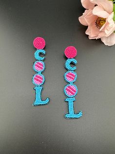 This is a beautiful Quirky beaded Earrings in Blue and Pink Cool(worded earrings) design. Very light weight to wear and looks good on any attire. This is very beautiful to look at and a perfect one for regular wear and also parties.  Color : Blue, Pink length : 4 inch width : 0.75 inch Each earring Weight : 3.7 grams Material : Beads, Fabric Beautiful High Quality, premium jewelry. Free US standard shipping. Hand crafted in India with the finest design, this earring is of premium quality and uni Fun Dangle Earrings For Festivals, Fun Dangle Earrings For Festival, Trendy Beaded Earrings For Party, Trendy Beach Earrings With Colorful Beads, Trendy Dangling Beads Earrings For Beach, Trendy Beach Earrings With Dangling Beads, Trendy Beaded Earrings For Beach, Trendy Round Beaded Earrings For Beach, Trendy Colorful Beaded Earrings For Beach