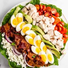 a white plate topped with salad and hard boiled eggs