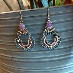 a pair of blue and pink beaded earrings