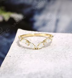 a gold ring with three stones on it