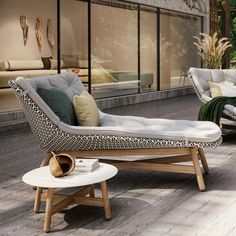 an outdoor lounge area with chairs and tables