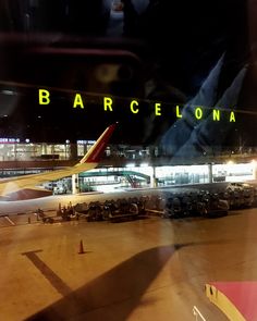 an airport at night with planes parked on the tarmac