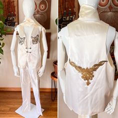 "Fun homemade 70s cream satin vest with sequin and gold beaded appliqués ! This came from an estate collection of costumes.  I'm not sure if this person was a singer or magician or what!  Perfect for a stage performer, rocker, etc.!  Comes with a cream satin scarf to style however you want!  I have a black version as well in this style with different patches, if you want to check out my shop.  DETAILS: Good Condition  70s Era Cream satin Vest has sequin flower appliqués on chest Silver tone metal buttons with chains for closure Back has a large gold floral like beaded appliqué Straight hem Trouser style pants with pockets  Zipper front Silver sequin trim down sides Cream satin oblong scarf  FLAWS: **recommend a dry clean **scarf has gray lines and dots, some yellowing **coffee stains on le Vintage Fitted Bottoms For Festival, Fitted Vintage Costume Bottoms, Vintage Fitted Bottoms For Costume, Magician Costume, Vintage Booth, Sequin Vest, Sequin Flower, Satin Scarf, 70s Era